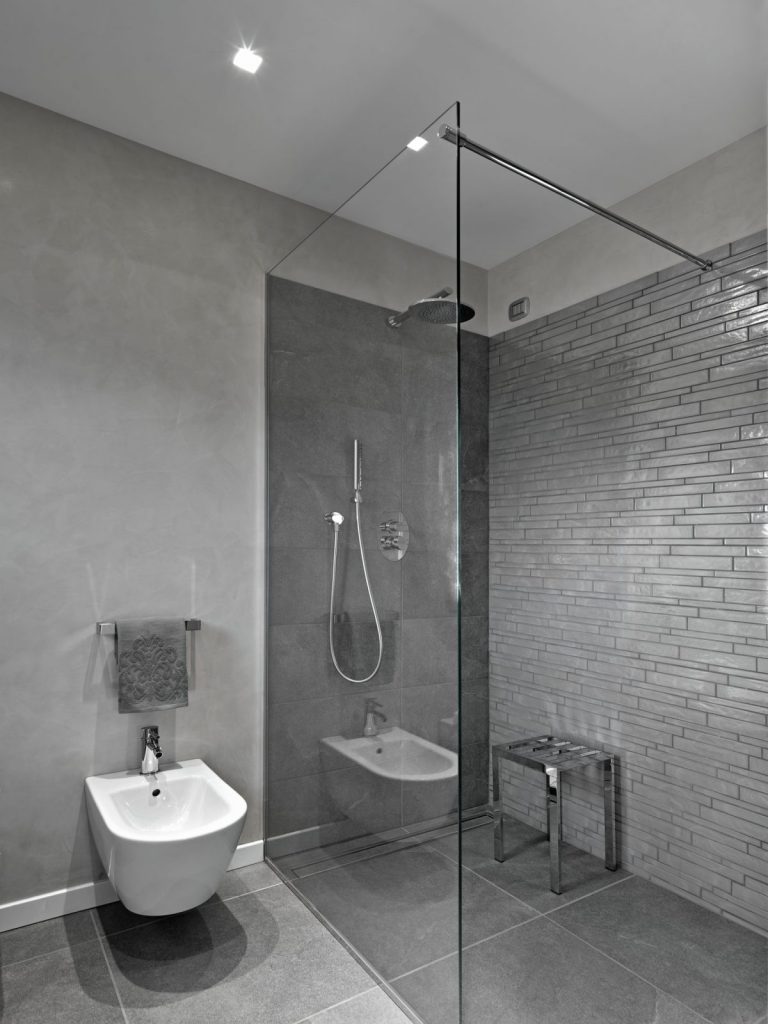 modern-bathroom-interior-with-glass-shower-box-bidet-foregorund-scaled-e1690974350916.jpg